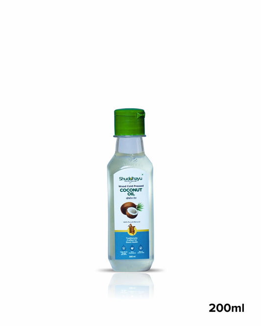 Bottle of coconut oil with a green cap on a white background